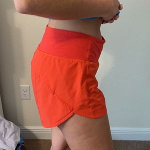 Orange speedup Lululemon shorts 4inch length size8